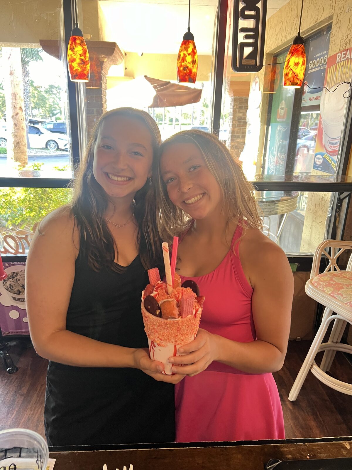 Friends sharing milkshakes
